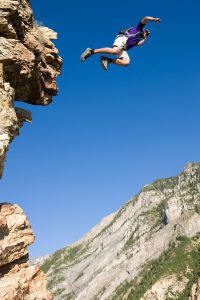 BASE Jumper Leaping Off Cliff
