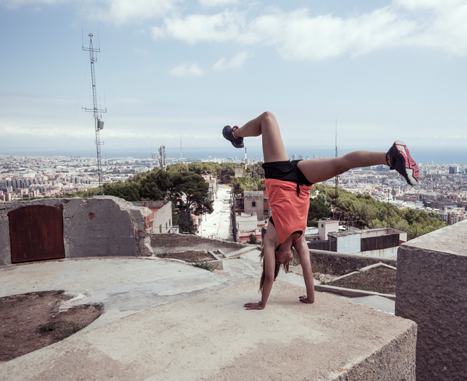 Young woman doing handstand practicing parkour in Barcelona Catalonia Spain